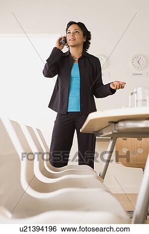 Stock Photograph - Businesswoman talking on phone. Fotosearch