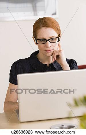 Stock Image - Businesswoman using laptop. Fotosearch