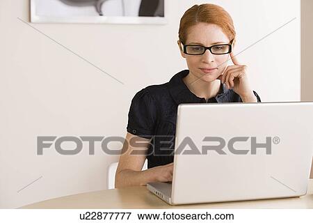 Businesswoman using laptop View Large Photo Image Stock Photo - Businesswoman using laptop. Fotosearch