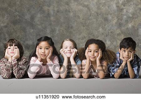 Children (6-7, 8-9) lying on floor, studio shot View Large Photo Image Stock Image - Children (6-7, 8-9) lying on floor, studio shot. Fotosearch