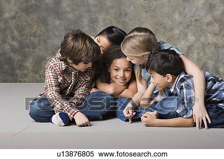 Stock Photography - Children (6-7, 8-9) playing together, studio shot. Fotosearch