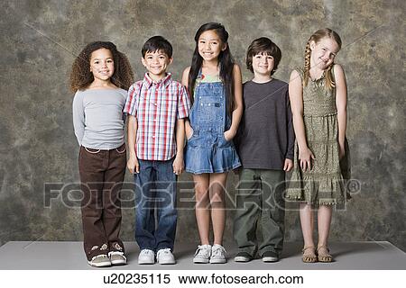 Stock Photography - Children (6-7, 8-9) posing, studio shot. Fotosearch