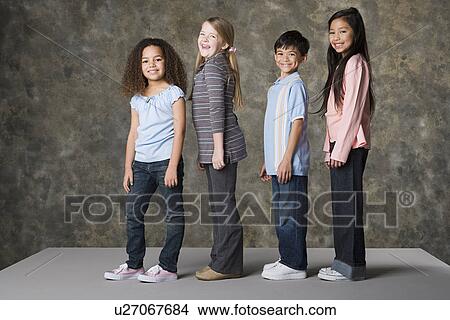 Picture - Children (6-7, 8-9) posing together, studio shot. Fotosearch