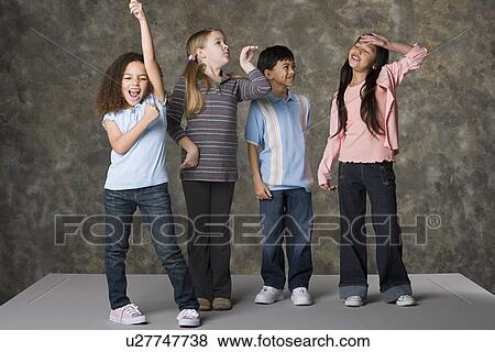 Stock Photo - Children (8-9) dancing, studio shot. Fotosearch