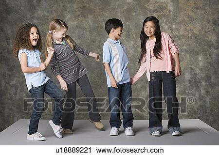 Children (8-9) dancing together, studio shot View Large Photo Image Stock Image - Children (8-9) dancing together, studio shot. Fotosearch