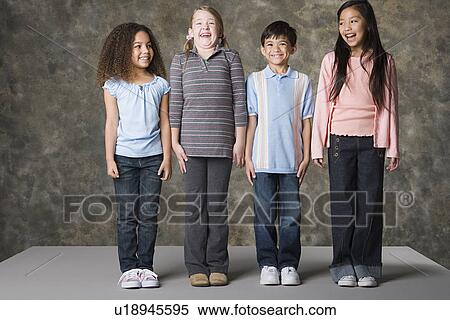 Children (8-9) laughing together, studio shot View Large Photo Image Stock Photography - Children (8-9) laughing together, studio shot. Fotosearch