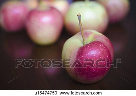 Stock Image - Close up of apples on table. Fotosearch