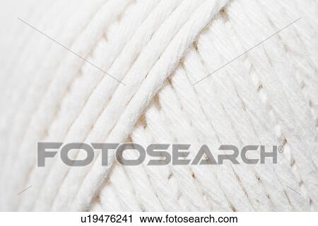 Stock Image - Close-up of ball of white yarn. Fotosearch