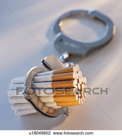 Close up of bunch of cigarettes locked in handcuffs View Large Photo Image Stock Image - Close up of bunch of cigarettes locked in handcuffs. Fotosearch