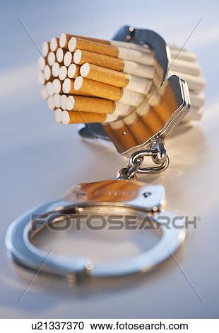 Close up of bunch of cigarettes locked in handcuffs View Large Photo Image Stock Image - Close up of bunch of cigarettes locked in handcuffs. Fotosearch