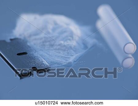 Close up of cocaine and blow tube on blue background View Large Photo Image Picture - Close up of cocaine and blow tube on blue background. Fotosearch
