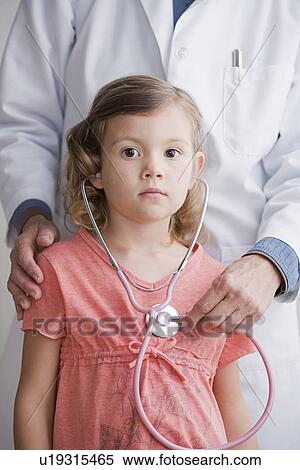 Close up of doctor and girl (4-5) listening to stethoscope View Large Photo Image Stock Photography - Close up of doctor and girl (4-5) listening to stethoscope. Fotosearch