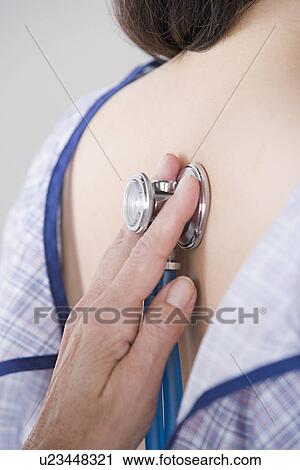 Close up of doctor's hand examining woman with stethoscope View Large Photo Image Stock Image - Close up of doctor's hand examining woman with stethoscope. Fotosearch