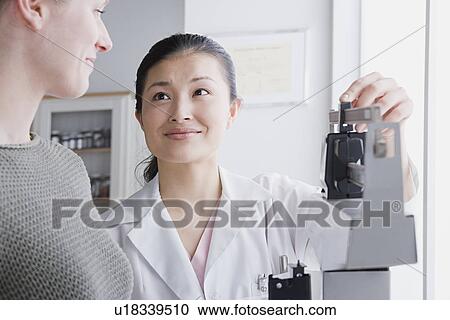 Close up of female doctor measuring woman's weight View Large Photo Image Stock Image - Close up of female doctor measuring woman's weight. Fotosearch