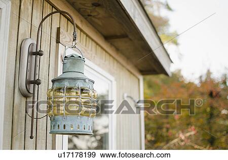 Stock Photo - Close up of lantern on wooden hut. Fotosearch