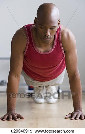 Stock Photography - Close up of man doing push-ups. Fotosearch