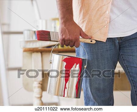 Close up of man's hand holding pain brush and paint can View Large Photo Image Stock Image - Close up of man's hand holding pain brush and paint can. Fotosearch