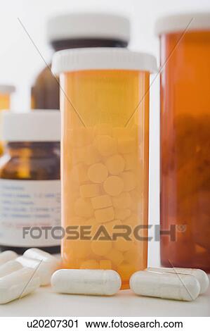 Stock Image - Close up of pill containers. Fotosearch