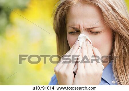 Picture - Close up of woman sneezing. Fotosearch