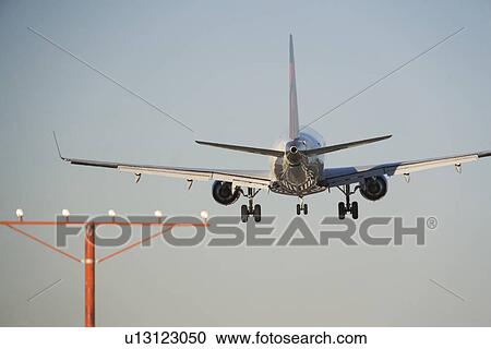 Commercial aeroplane taking off from runway View Large Photo Image Stock Image - Commercial aeroplane taking off from runway. Fotosearch