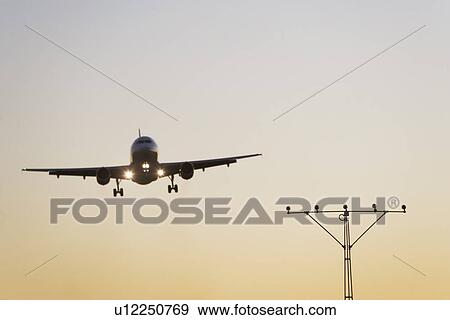 Stock Photo - Commercial aeroplane taking off from runway. Fotosearch