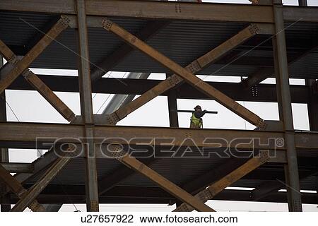 Construction worker working on unfinished structure View Large Photo Image Stock Image - Construction worker working on unfinished structure. Fotosearch