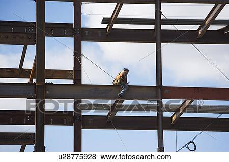 Stock Photo - Construction worker working on unfinished structure. Fotosearch