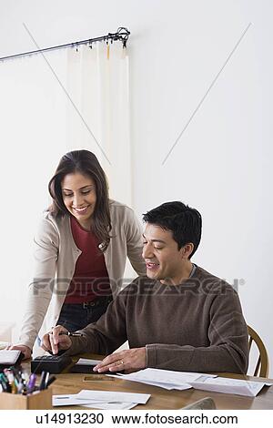 Couple doing paperwork at home View Large Photo Image Stock Image - Couple doing paperwork at home. Fotosearch