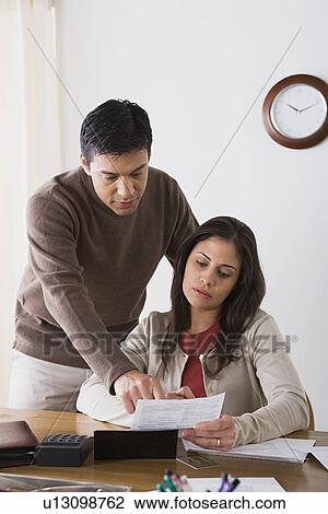 Couple doing paperwork View Large Photo Image Stock Image - Couple doing paperwork. Fotosearch