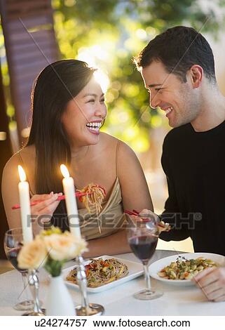 Stock Photo - Couple enjoying fine meal in restaurant. Fotosearch