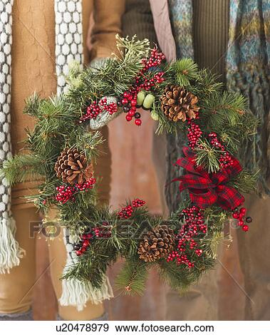 Stock Photo - Couple holding christmas wreath. Fotosearch