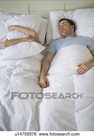 Couple in bed, man snoring View Large Photo Image Stock Photograph - Couple in bed, man snoring. Fotosearch