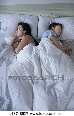 Stock Image - Couple in bed. Fotosearch