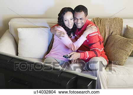 Picture - Couple watching tv. Fotosearch