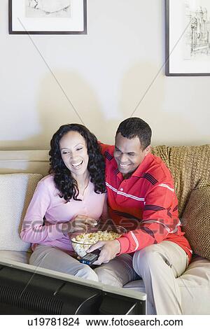 Picture - Couple watching tv. Fotosearch