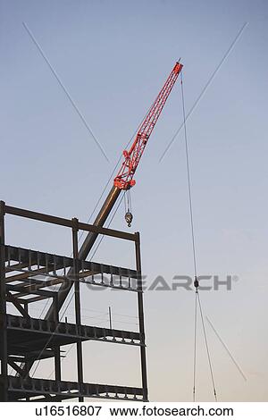Stock Photo - Crane with unfinished built structure. Fotosearch