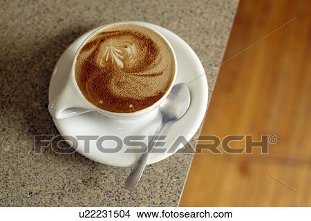 Cup of coffee on table View Large Photo Image Picture - Cup of coffee on table. Fotosearch