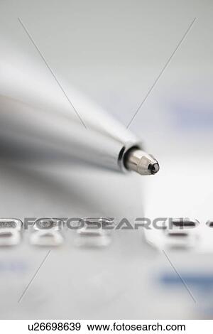 Stock Photo - Detail of credit card with ballpoint pen, studio shot. Fotosearch