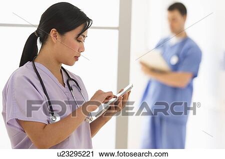Stock Image - Doctor and nurse in hospital. Fotosearch
