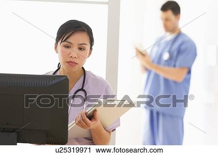 Stock Image - Doctor and nurse in hospital. Fotosearch