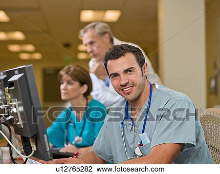 Doctor and surgeons working on computers in hospital View Large Photo Image Stock Image - Doctor and surgeons working on computers in hospital. Fotosearch