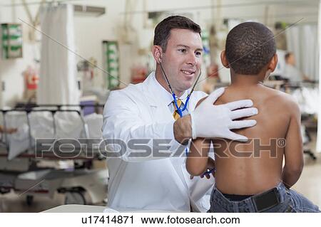 Doctor examining boy (4-5) in hospital View Large Photo Image Stock Image - Doctor examining boy (4-5) in hospital. Fotosearch