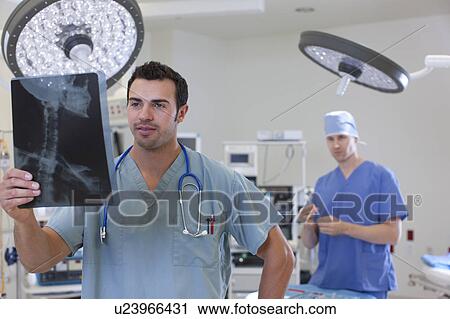 Stock Image - Doctor looking at x-ray. Fotosearch