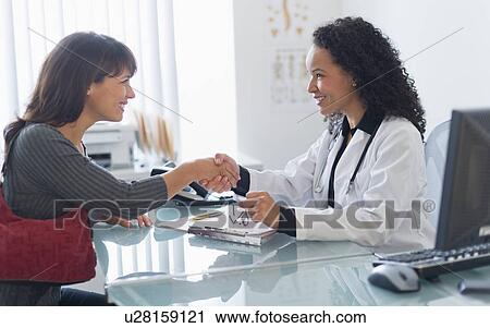 Doctor with patient in office View Large Photo Image Stock Image - Doctor with patient in office. Fotosearch