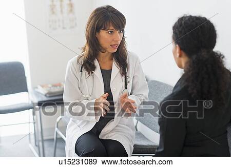 Stock Photo - Doctor with patient in office. Fotosearch