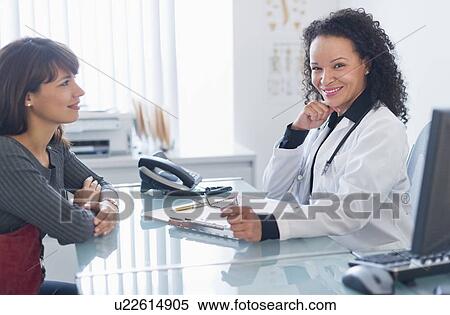 Doctor with patient in office View Large Photo Image Stock Photography - Doctor with patient in office. Fotosearch