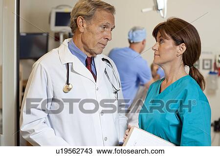 Stock Image - Doctors looking at each other. Fotosearch