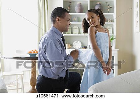 Father adjusting Daughter's (10-11) dress View Large Photo Image Stock Image - Father adjusting Daughter's (10-11) dress. Fotosearch