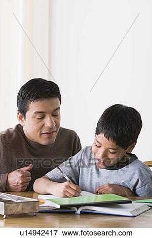 Father doing homework with son (10-11) View Large Photo Image Stock Photo - Father doing homework with son (10-11). Fotosearch