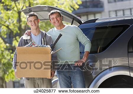 Father helping teenage son (16-17) packing to college View Large Photo Image Stock Photo - Father helping teenage son (16-17) packing to college. Fotosearch